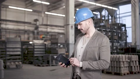 Proud engineer using tablet computer in industrial hall for data analysis Stock Footage 149297061