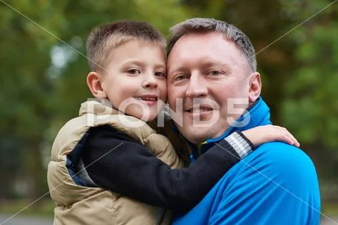 Proud father hugging his son outside Stock Photos