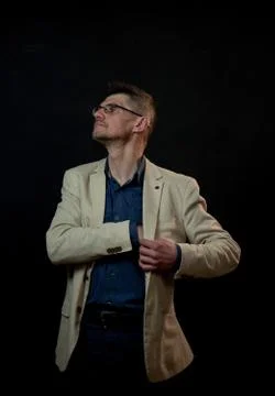 Proud guy in white classic jacket holds hand in pocket Stock Photos