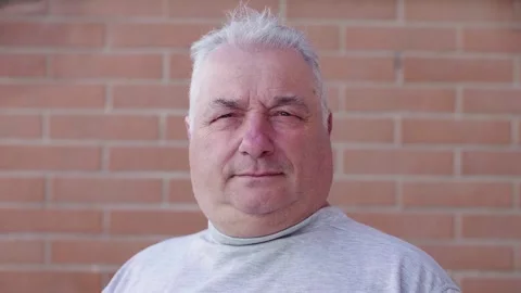 Proud mature man looking at the camera with a friendly expression Stock Footage 295141189