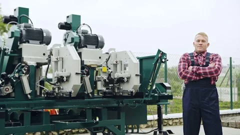 Proud worker posing with huge machine Stock Footage 82687182