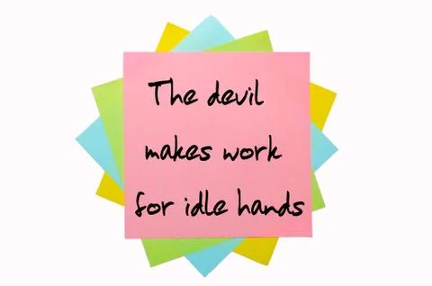 Proverb " the devil makes work for idle hands " written on bunch of sticky no Stock Photos