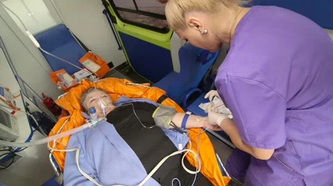 Provide emergency medical care to senior person with symptoms of a heart attack Stock Footage 56850400