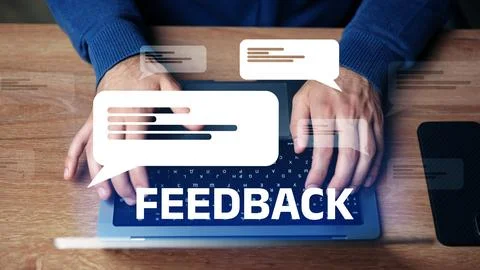 Providing feedback through a digital interface while typing on a laptop at a Stock Photos