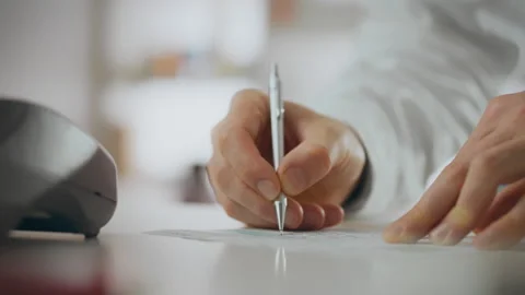 Provision of services. A pharmacy worker writes with pen, signing a doctor's Stock Footage 331287742