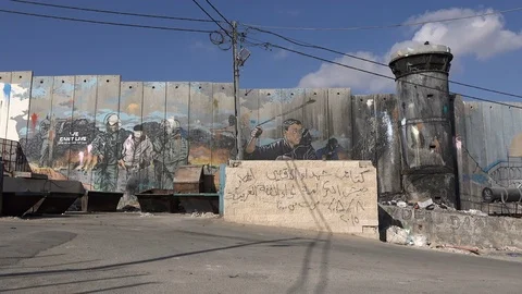 Provocative graffiti art on the separation wall in Bethlehem West Bank Stock Footage 71488284