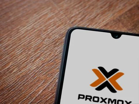Proxmox Virtual Environment app launch screen on smartphone on wooden backg.. Stock Photos