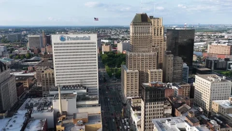 Prudential logo marks white office tower above busy downtown street in Newark Stock Footage 340971171