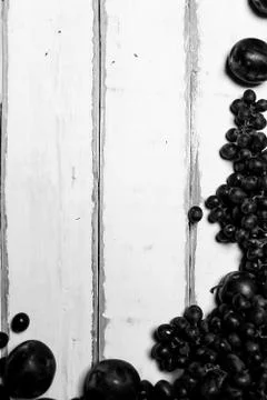 Prunes and grapes on the table Stock Photos