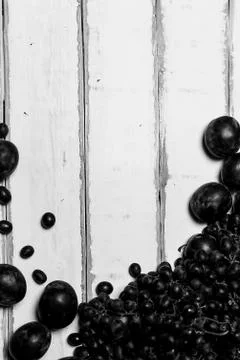 Prunes and grapes on the table Stock Photos