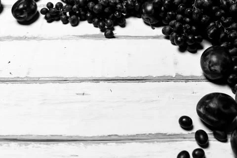 Prunes and grapes on the table Stock Photos