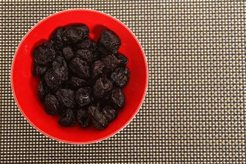Prunes on a texture background Stock Photos