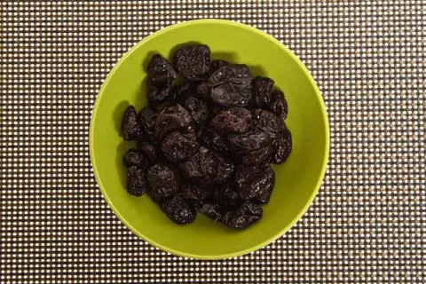 Prunes on a texture background Stock Photos