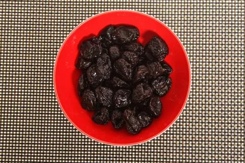 Prunes on a texture background Stock Photos