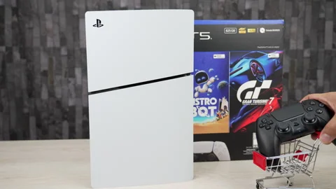 PS5 Slim Vertical in Front of Astro Bot and Gran Turismo 7 Bundle Box Stock Footage 345008596