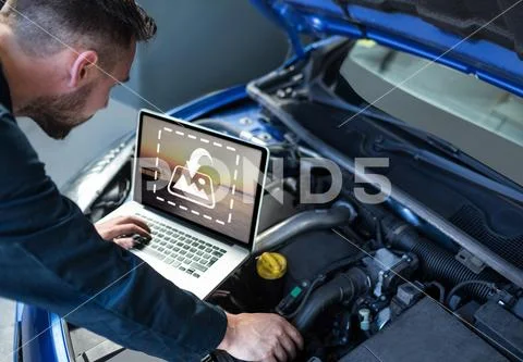 PSD template of car mechanic using laptop while repair car engine in garage PSD Template