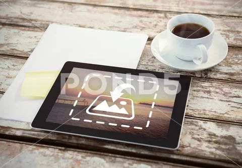 PSD template of digital tablet with blank paper and cup of coffee on wooden PSD Template