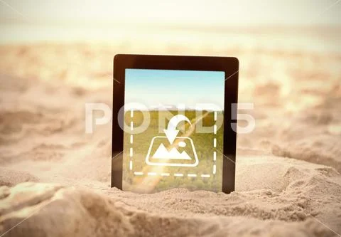 PSD template of digital tablet kept on sand at beach PSD Template
