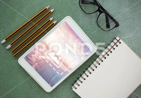 PSD template of digital tablet, pencil, diary and spectacle on table PSD Template