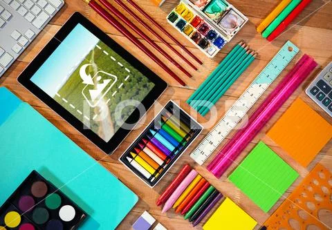 PSD template of digital tablet with various stationery on a table PSD Template