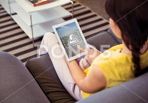 PSD template of Female business executive using digital tablet on sofa in office PSD Template