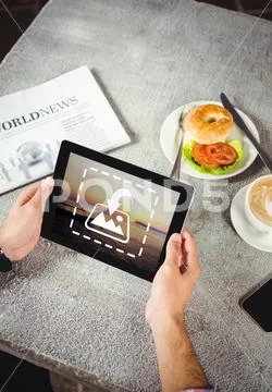 PSD template of Hands of man using digital tablet in cafeteria Modello PSD