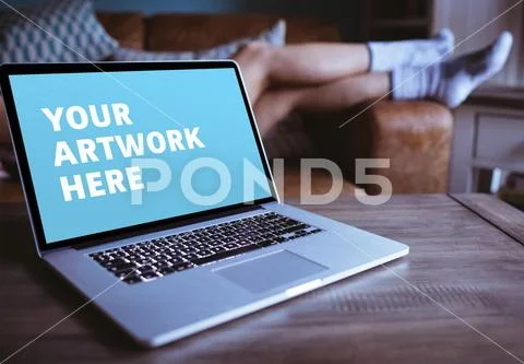 PSD template of laptop on wooden table at home PSD Template