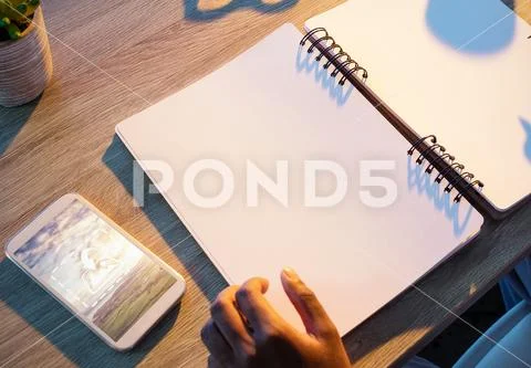 PSD template of male executive with mobile phone writing on notepad at desk in PSD Template