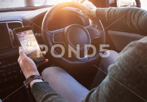 PSD template of man using mobile phone while driving car PSD Template