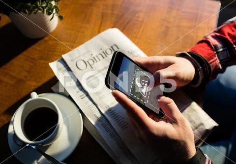 PSD template of man using mobile phone at table in cafe PSD Template