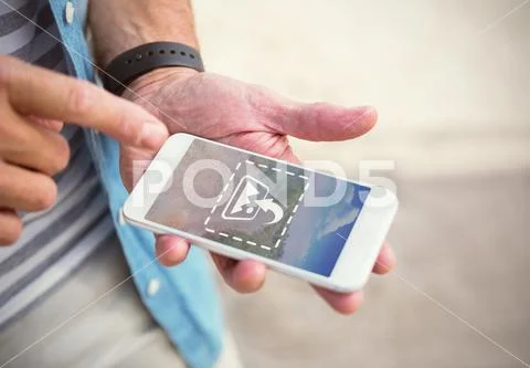 PSD template of mid section of man using mobile phone on beach PSD Template