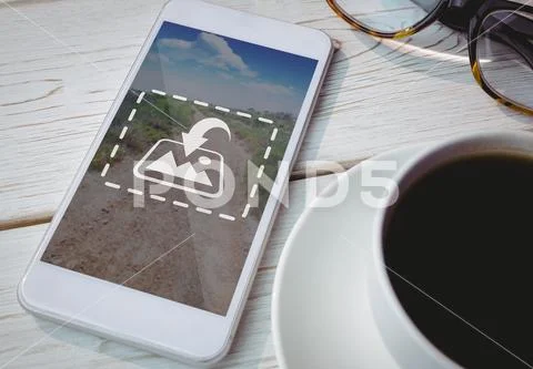 PSD template of mobile phone, coffee cup and spectacle on wooden table PSD Template