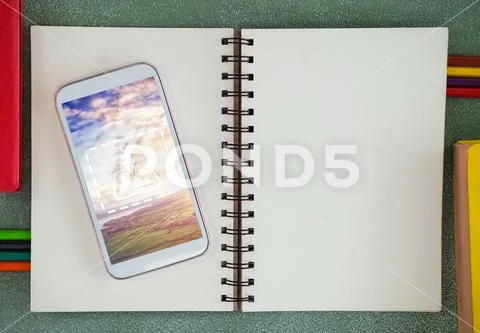 PSD template of mobile phone on diary at table PSD Template