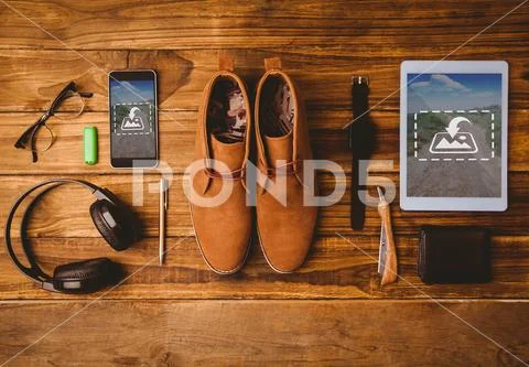PSD template of mobile phone, digital tablet and accessories on wooden table PSD Template