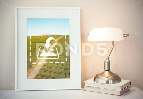 PSD template of picture frame with books and table lamp on table PSD Template