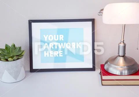 PSD template of picture frame with lamp, pot plant and book on desk PSD Template