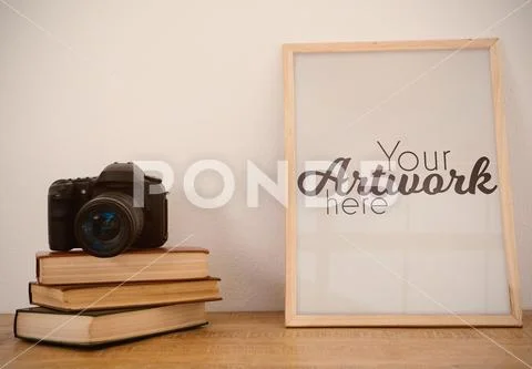 PSD template of picture frame on wooden table PSD Template