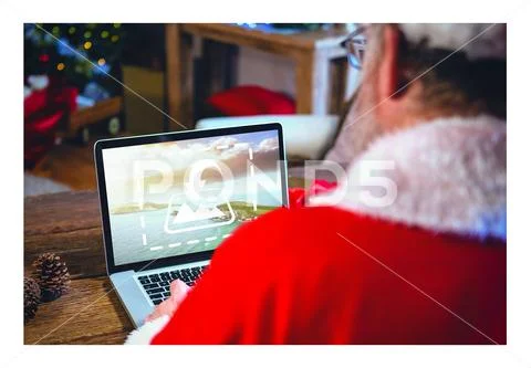 PSD template of Santa Claus using laptop at wooden table in home PSD Template