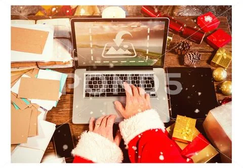 PSD template of Santa hand using laptop at wooden table during Christmas PSD Template
