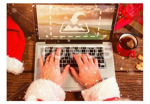 PSD template of Santa hand using laptop at wooden table during Christmas PSD Template