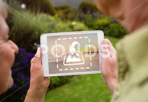 PSD template of senior couple using digital tablet in lawn PSD Template