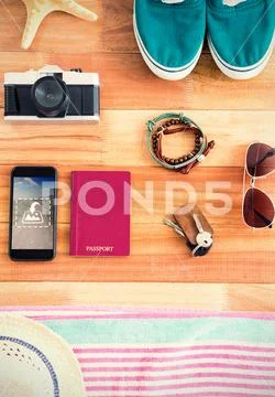 PSD template of smart phone and various accessories place on a wooden table PSD Template