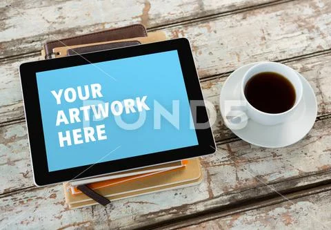 PSD template of tablet with spiral diary and coffee cup on table PSD Template