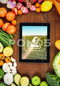 PSD template of vegetables and digital tablet on a wooden plank PSD Template