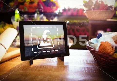 PSD template of wicker basket and digital tablet on the wooden table at a flower PSD Template