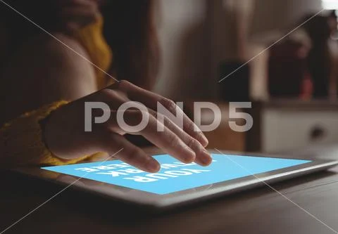 PSD template of woman using digital tablet at dining table in home PSD Template