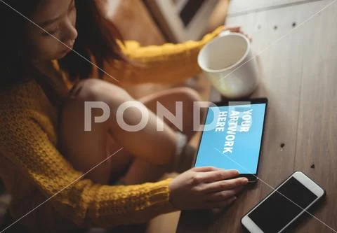 PSD template of woman using digital tablet while having coffee at dining table PSD Template