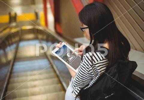 PSD template of Woman using digital tablet on escalator PSD Template