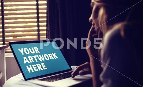 PSD template of woman using laptop on bed in bedroom at home PSD Template