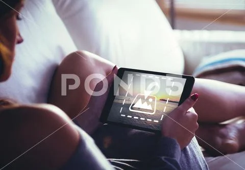 PSD template of woman using tablet sitting on the couch at home PSD Template
